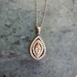 Teardrop shaped necklace with amber colored stone and cubic zirconia